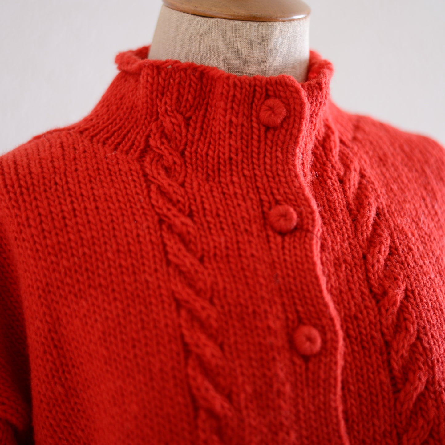 Wool hand knitted cable cardigan in red