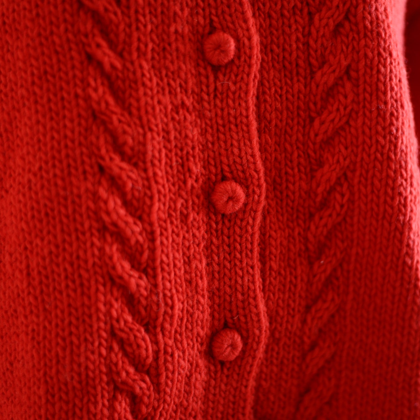 Wool hand knitted cable cardigan in red