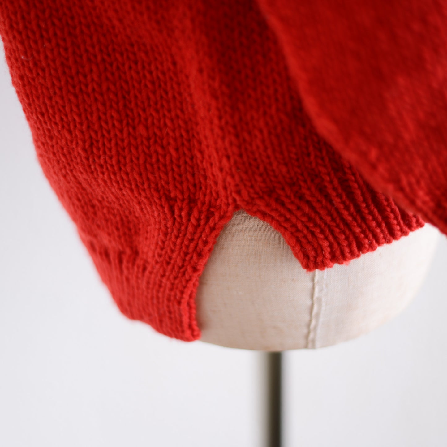 Wool hand knitted cable cardigan in red