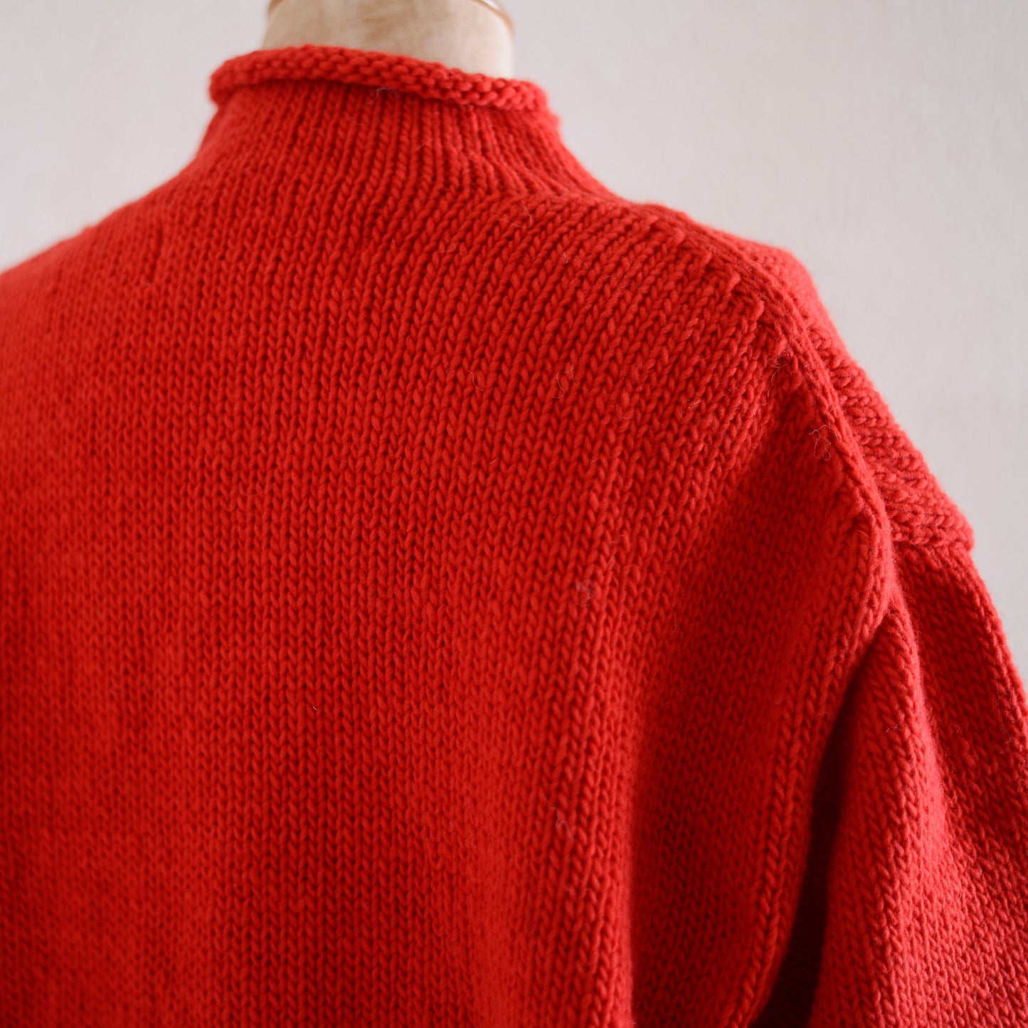 Wool hand knitted cable cardigan in red