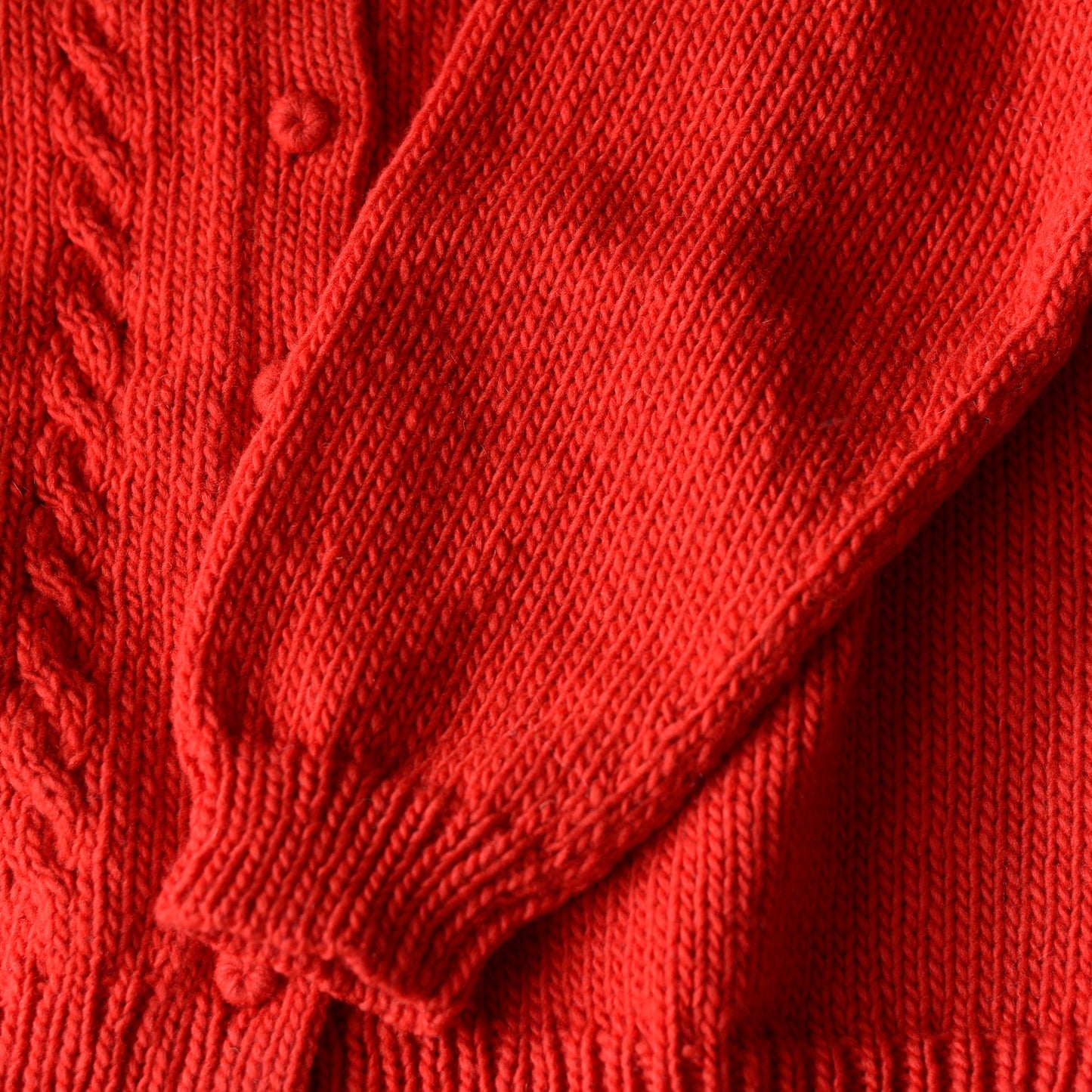 Wool hand knitted cable cardigan in red