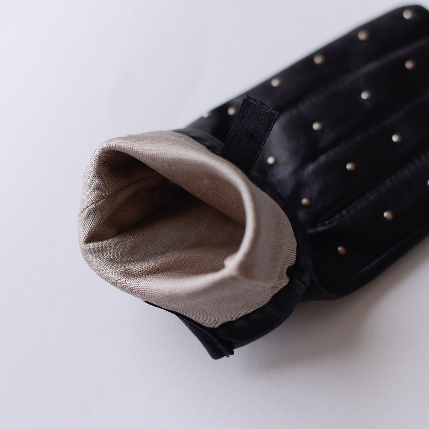 Silk-lined studded leather gloves in Black
